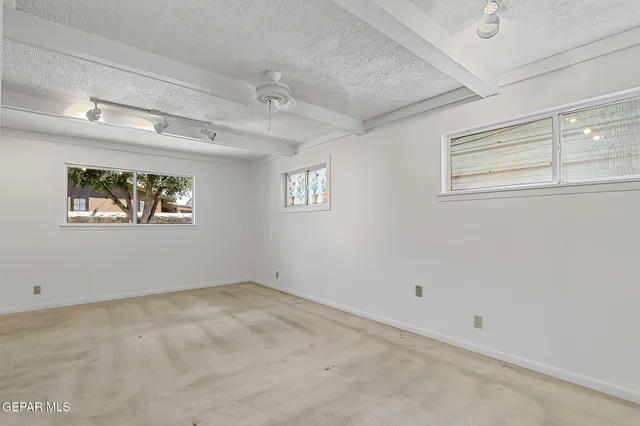 an aerial view of residential house with parking space and car parked
