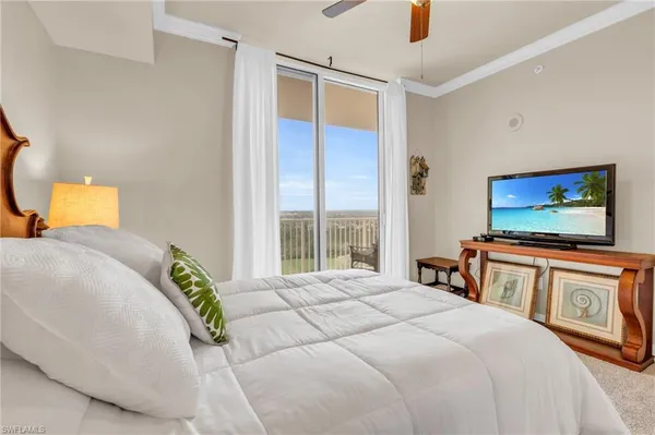 a bedroom with a bed and a flat screen tv