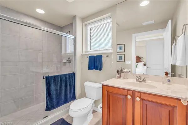 a bathroom with a granite countertop sink toilet and shower