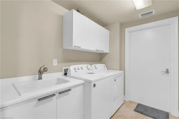 a room with a sink and cabinets