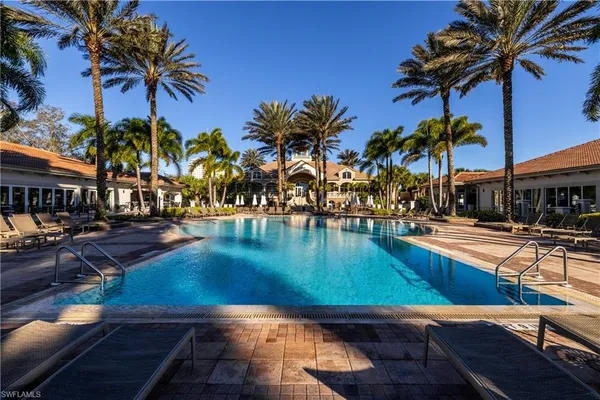 a view of a swimming pool with a table and chairs