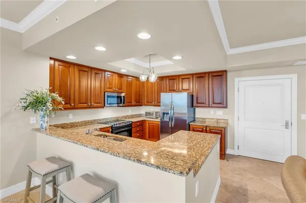 a kitchen with stainless steel appliances granite countertop sink stove and cabinets