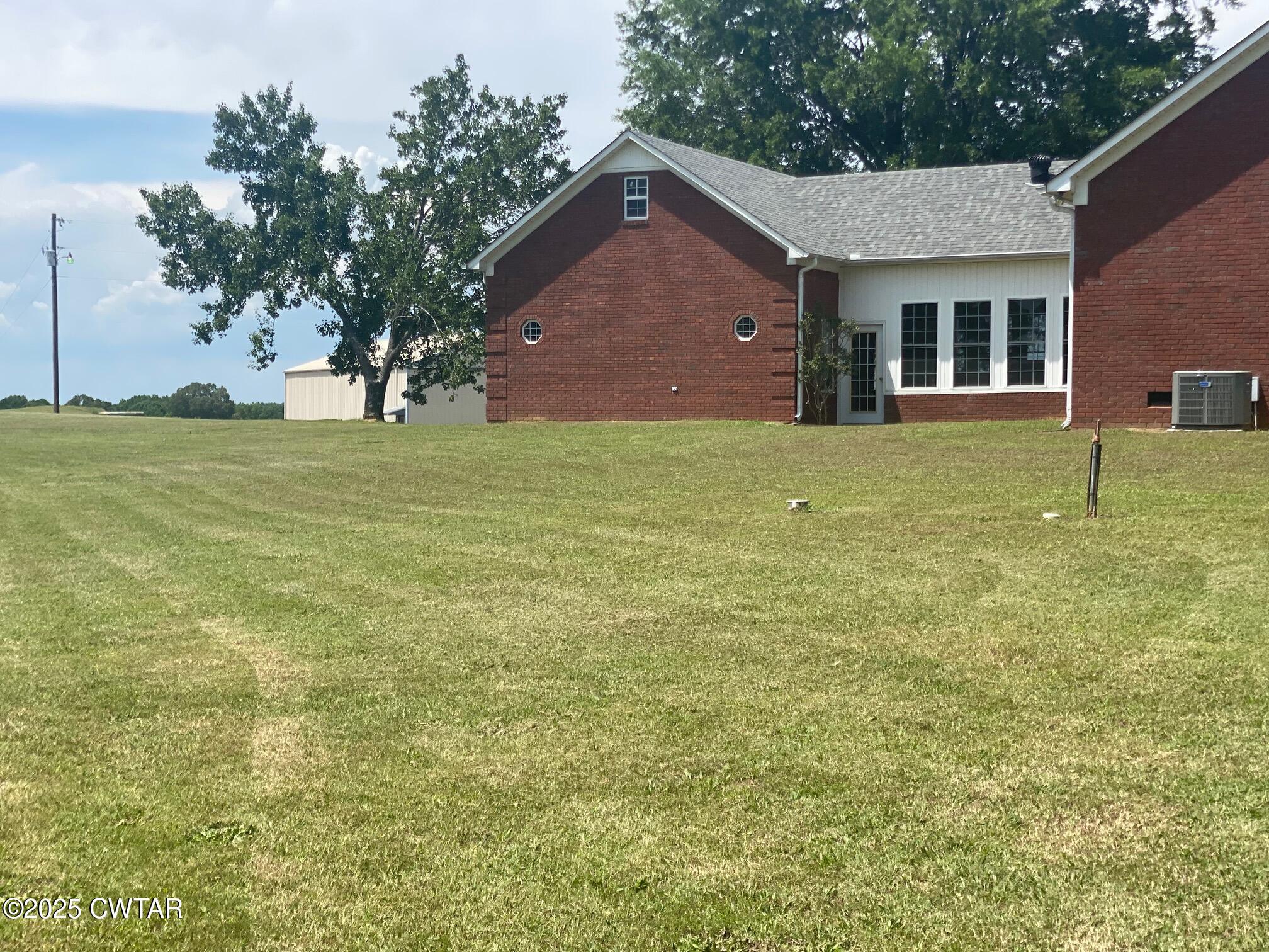 465 Garland Road Henderson, TN 38340 - Photo 14 of 31 a front view of house with yard and trees in the background