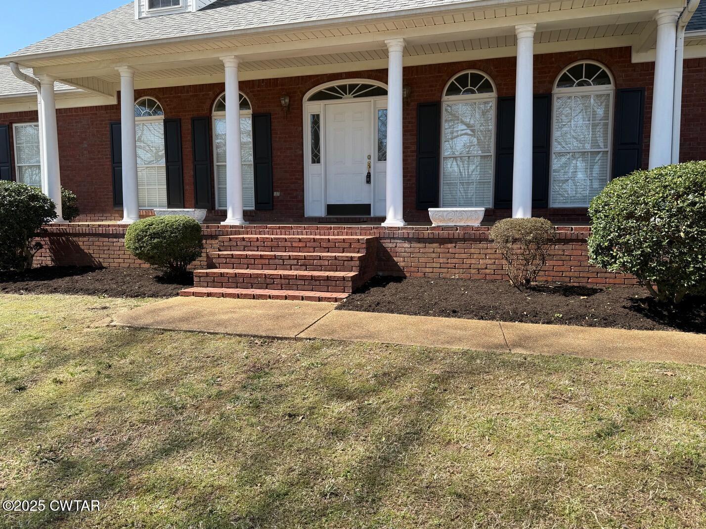 465 Garland Road Henderson, TN 38340 - Photo 2 of 31 a view of a house with potted plants and more windows