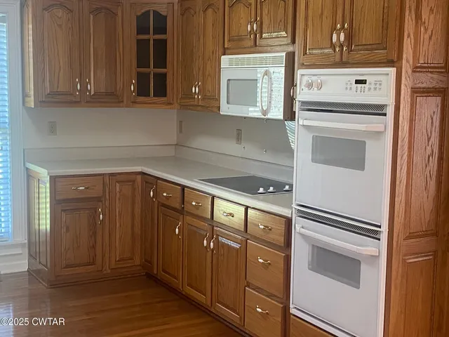 a kitchen with granite countertop stainless steel appliances and cabinets