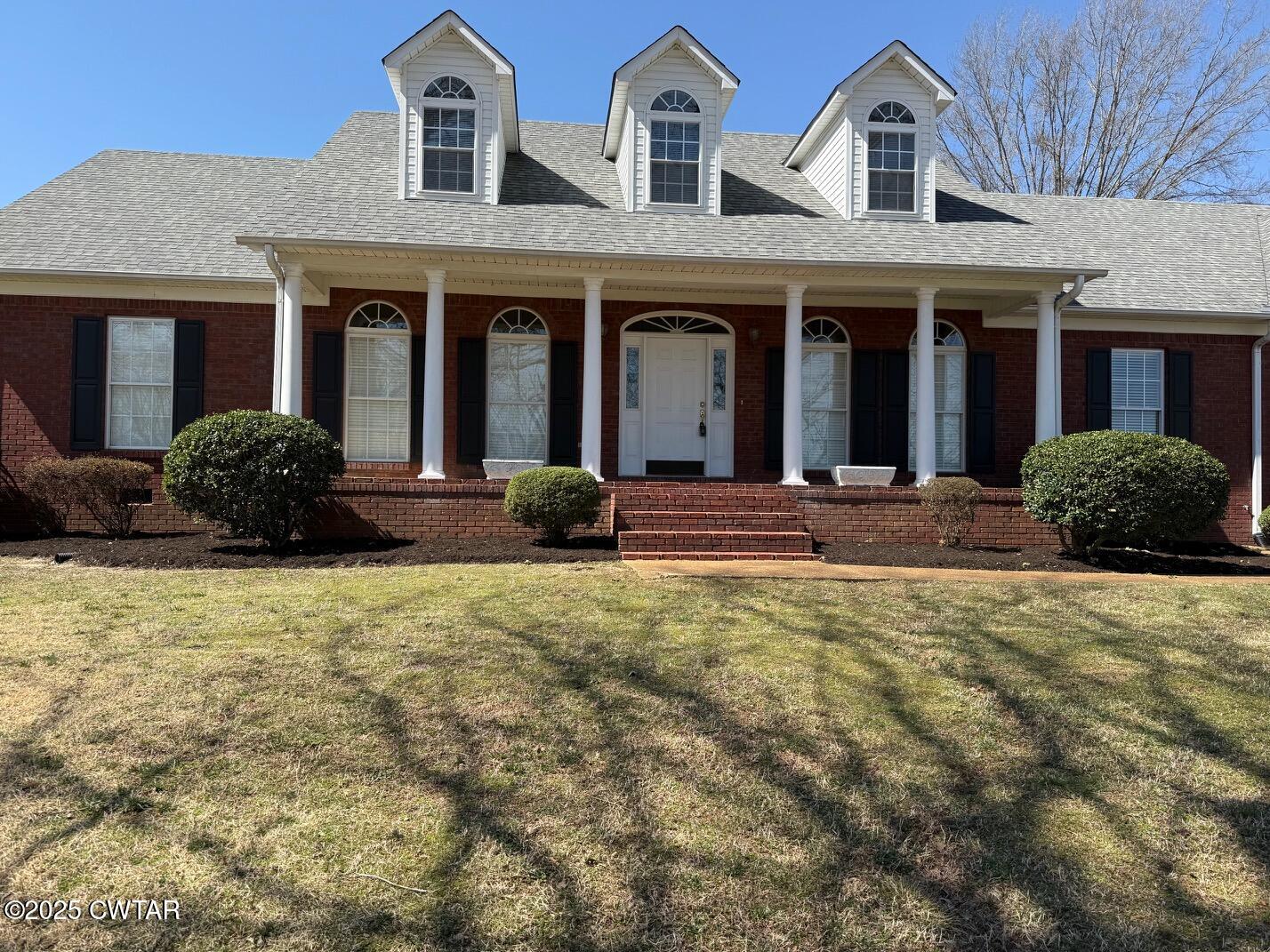 465 Garland Road Henderson, TN 38340 - Photo 31 of 31 front view of a brick house with a yard