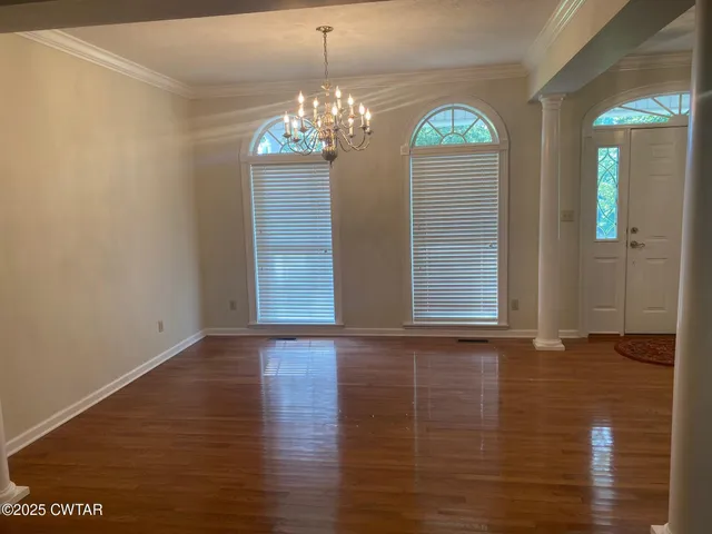 a view of an entryway with wooden floor