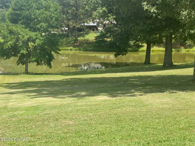 a view of a water fountain and a big yard