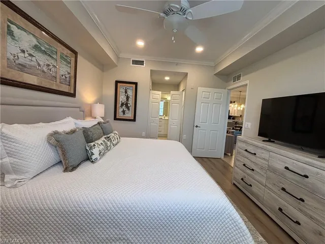 a bedroom with a large bed and a flat screen tv