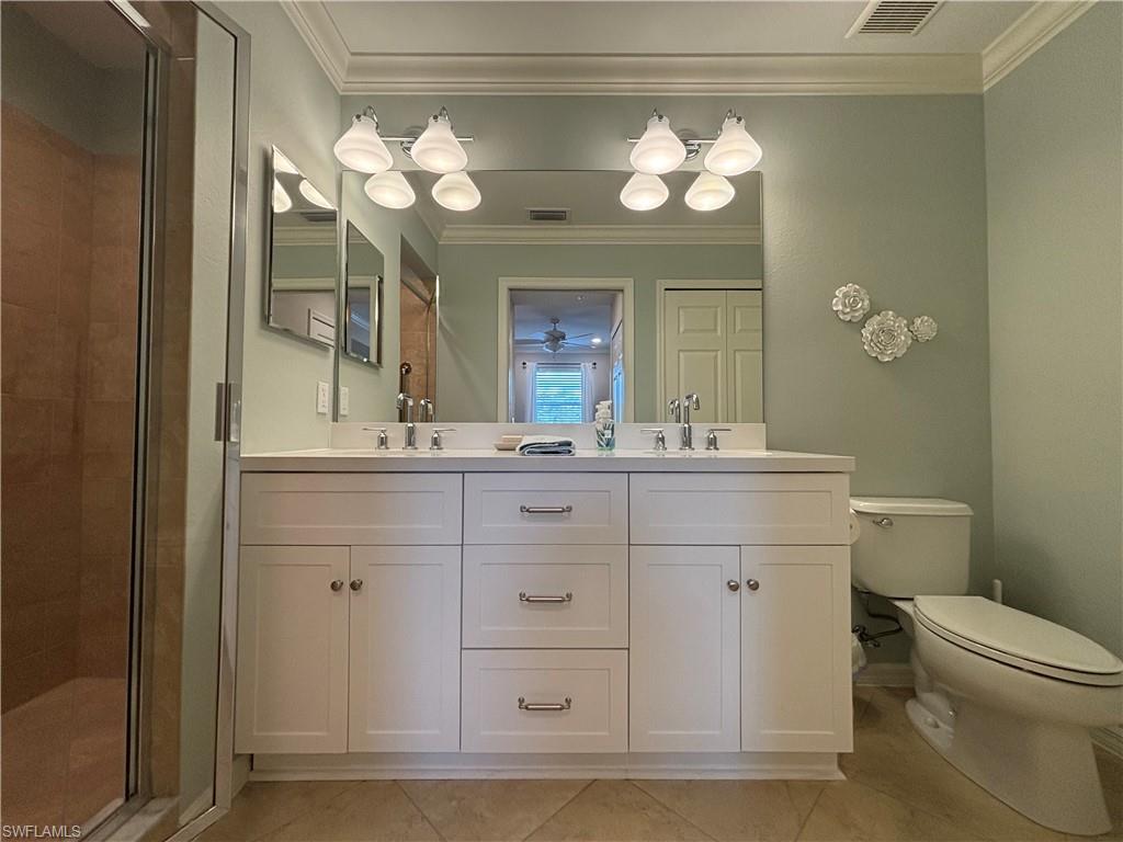 10341 Heritage Bay Boulevard, Unit 1924 Naples, FL 34120 - Photo 12 of 36 a bathroom with a sink vanity and a mirror