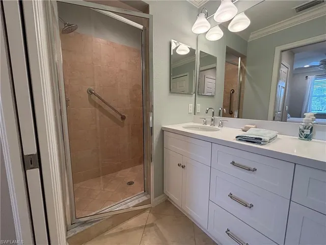 a bathroom with a shower sink and mirror