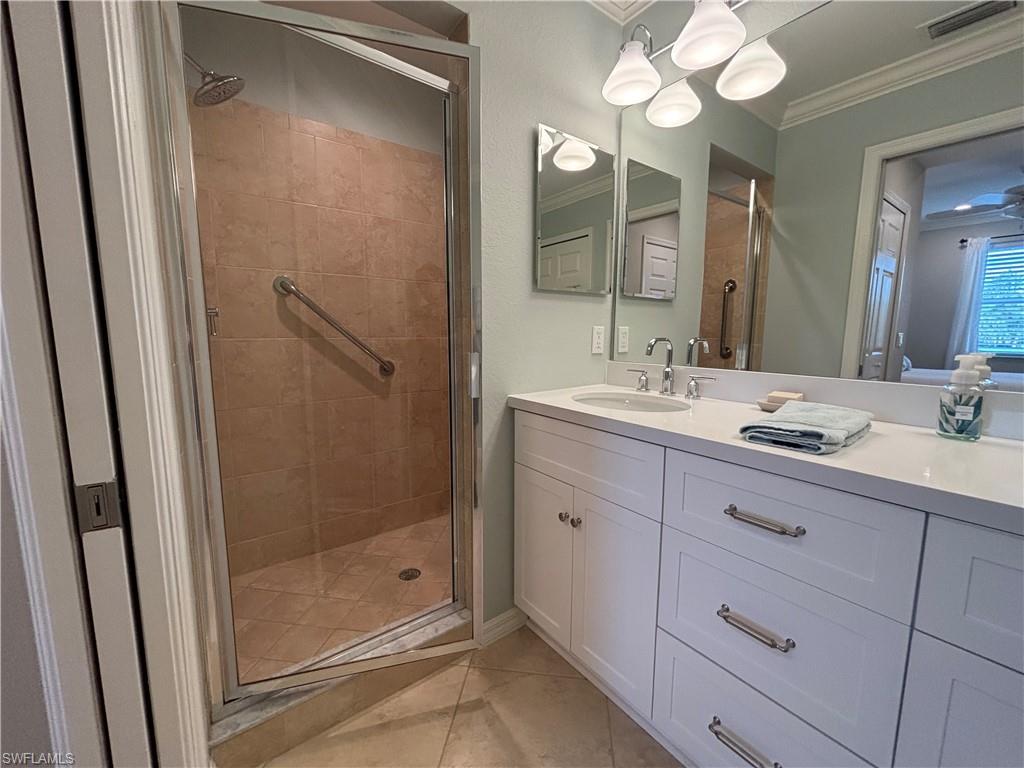 10341 Heritage Bay Boulevard, Unit 1924 Naples, FL 34120 - Photo 13 of 36 a bathroom with a shower sink and mirror
