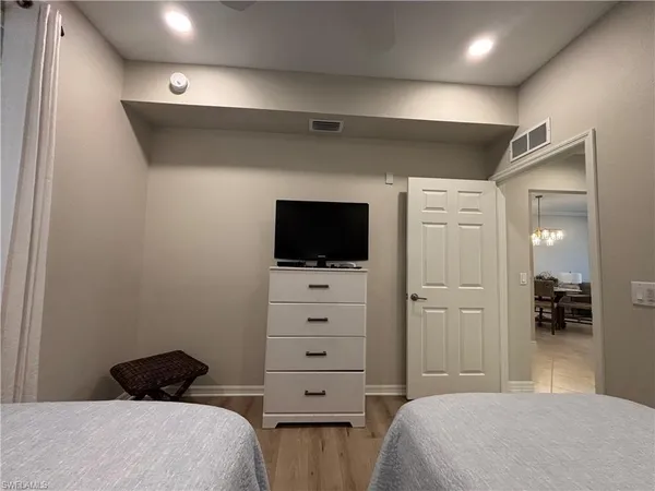a bedroom with a bed and a television