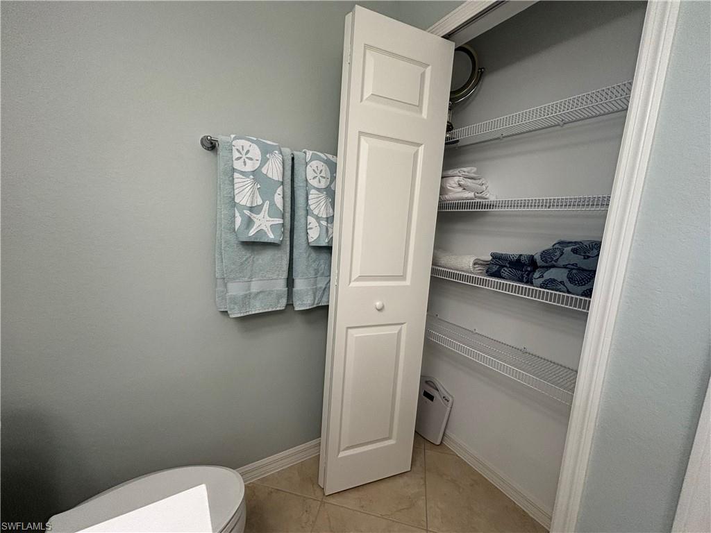 10341 Heritage Bay Boulevard, Unit 1924 Naples, FL 34120 - Photo 19 of 36 a bathroom with a toilet and a shower