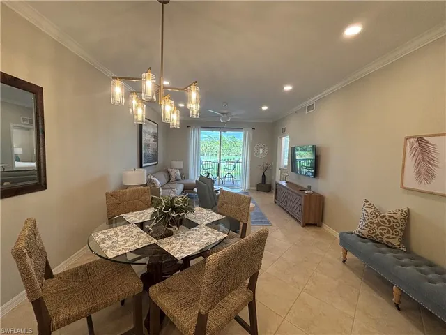 a view of a dining room with furniture and a chandelier