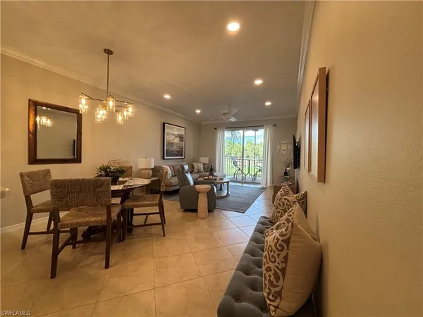 a living room with furniture window and potted plant