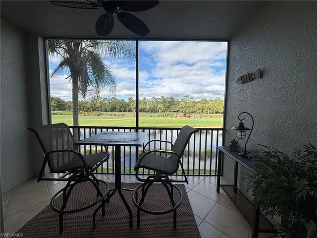 a view of a balcony with chairs and a potted plant