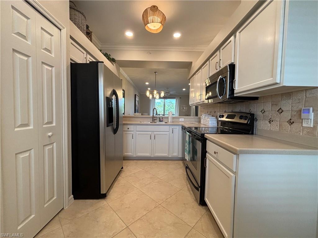 10341 Heritage Bay Boulevard, Unit 1924 Naples, FL 34120 - Photo 8 of 36 a kitchen with stainless steel appliances granite countertop a refrigerator and a sink