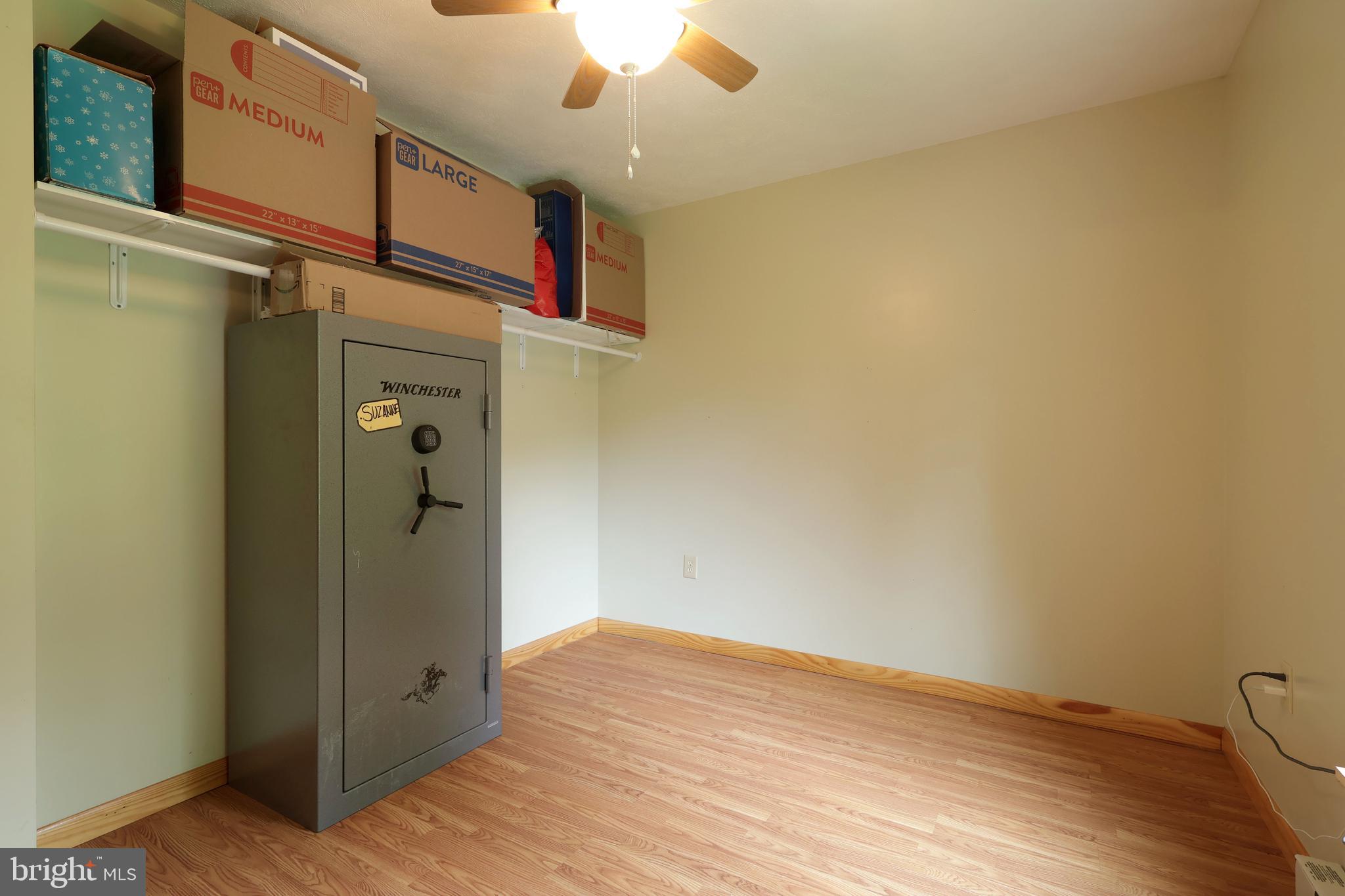 358 Buckridge Road Howard, PA 16841 - Photo 21 of 40 an empty room with wooden floor and fan