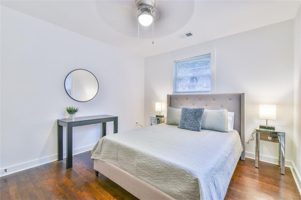 1225 Carter Road Decatur, GA 30030 - Photo 17 of 20 a bedroom with a bed and wooden floor