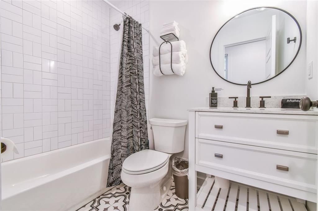 1225 Carter Road Decatur, GA 30030 - Photo 18 of 20 a bathroom with a sink mirror vanity and toilet