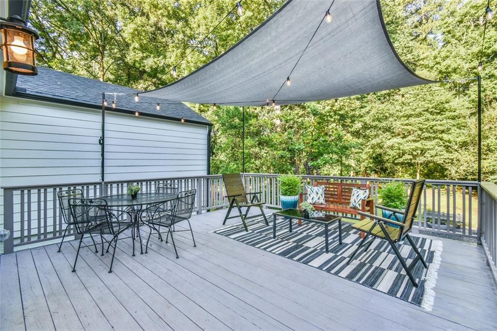1225 Carter Road Decatur, GA 30030 - Photo 7 of 20 a balcony with wooden floor table and chairs