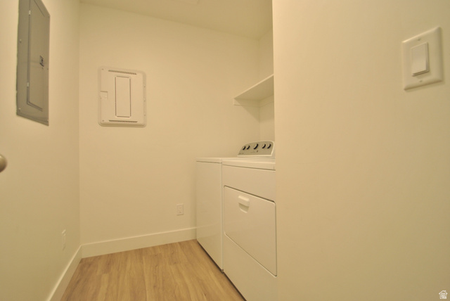 1219 West 1870 South Logan, UT 84321 - Photo 13 of 18 Washroom featuring light wood-style flooring, electric panel, and washer and dryer