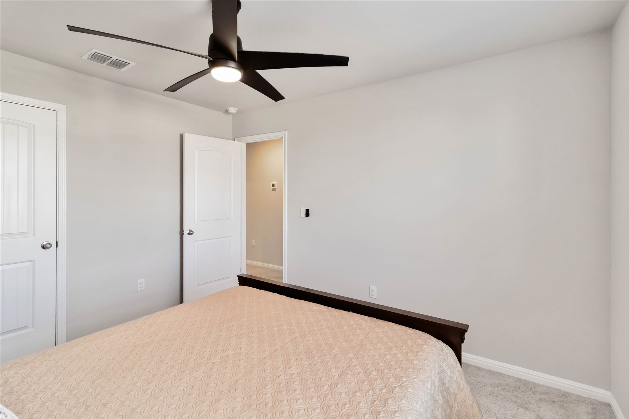 103 Mariners Landing Bastrop, TX 78602 - Photo 18 of 25 a bedroom with a bed and a ceiling fan