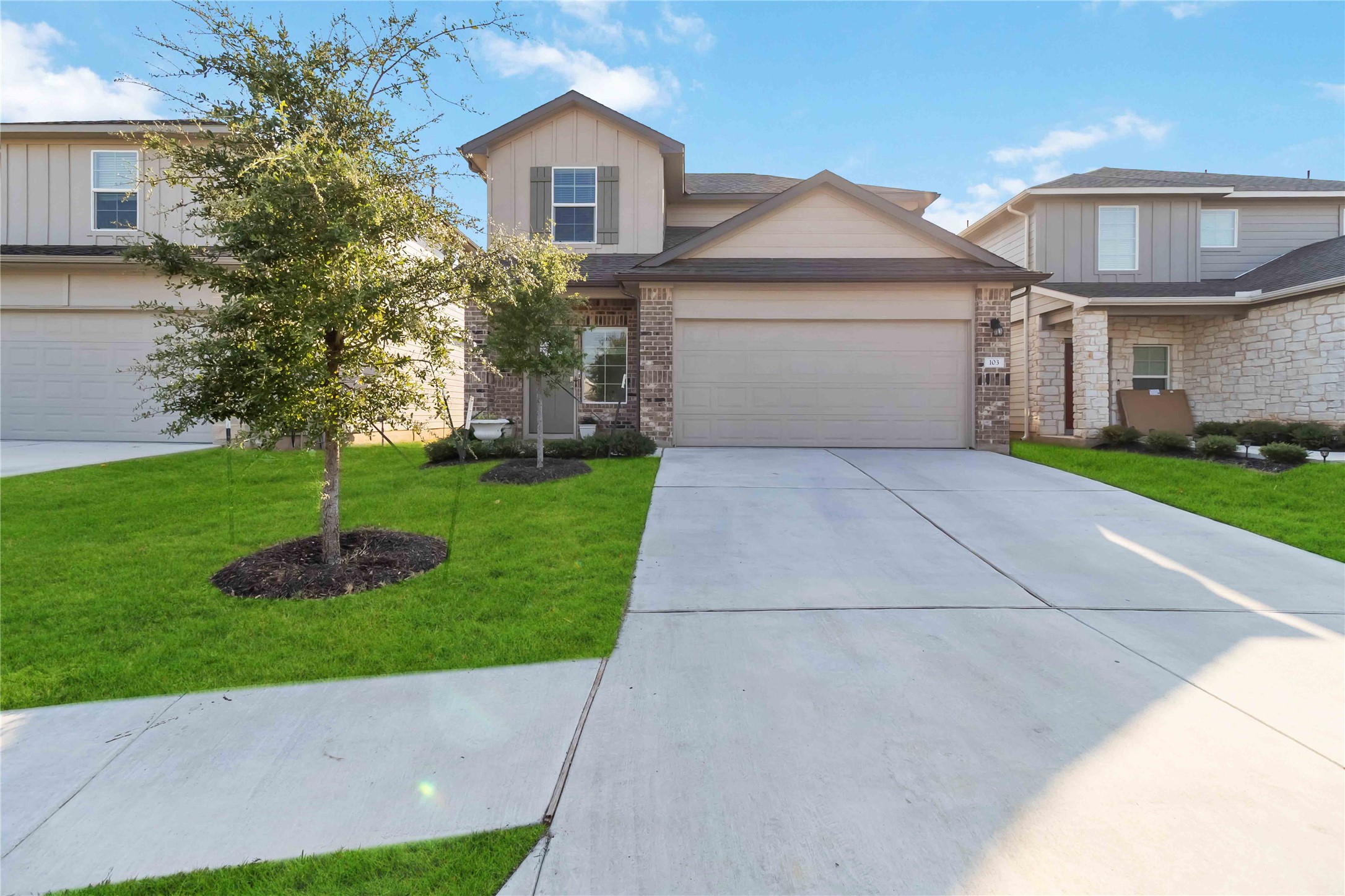 103 Mariners Landing Bastrop, TX 78602 - Photo 2 of 25 a front view of a house with a garden and yard