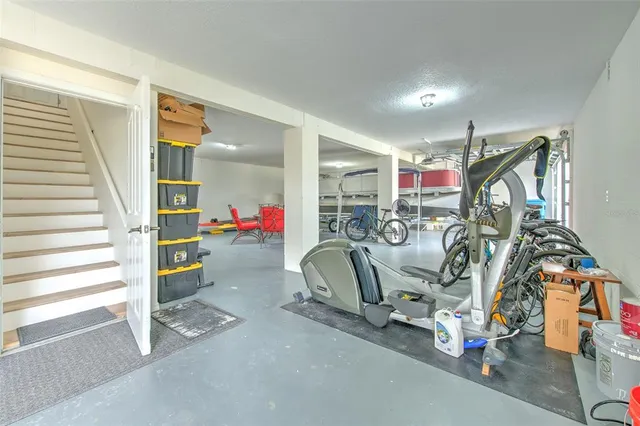a living room with furniture wooden floor and a kitchen view