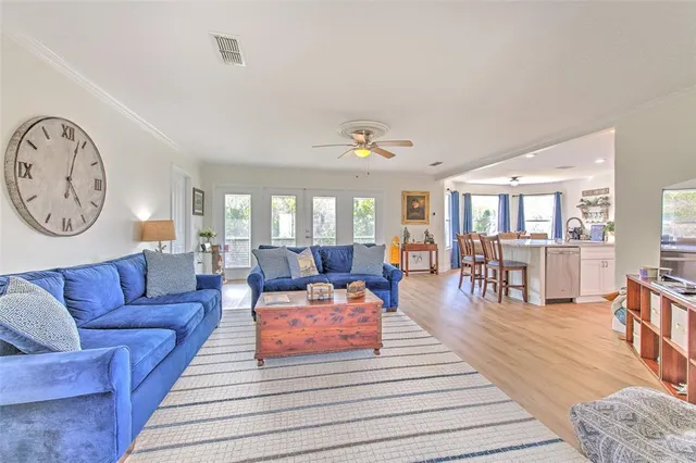 a large kitchen with kitchen island granite countertop lots of white cabinets appliances and a dining table