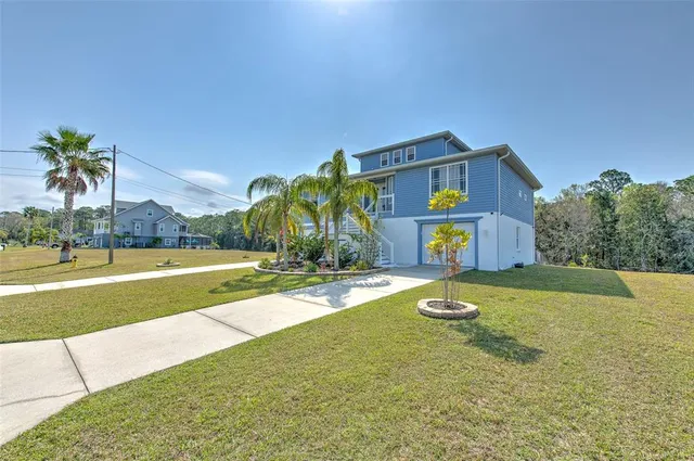 an aerial view of residential houses with outdoor space and seating