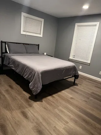 a bedroom with a bed and a night stand