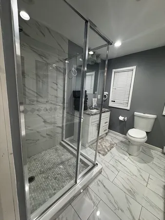 a bathroom with a toilet and a shower