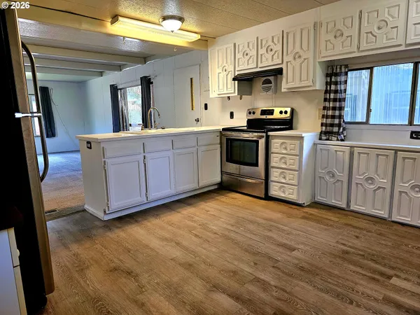 a kitchen with stainless steel appliances granite countertop a stove a sink and a granite counter tops