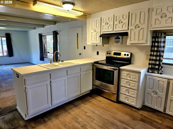 a kitchen with stainless steel appliances granite countertop a stove and a sink