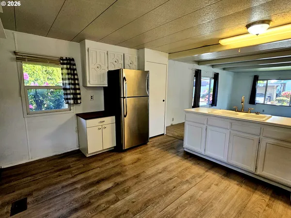 a kitchen with stainless steel appliances a refrigerator and wooden cabinets