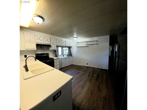 a kitchen with a sink a stove and cabinets