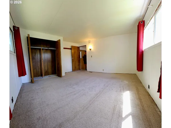 a view of empty room with closet