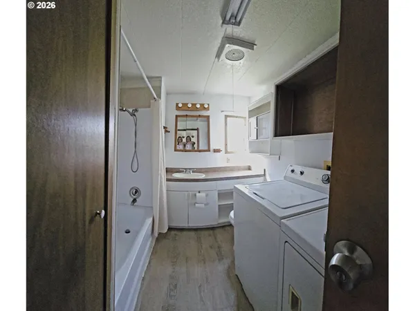 a utility room with cabinets washer and dryer