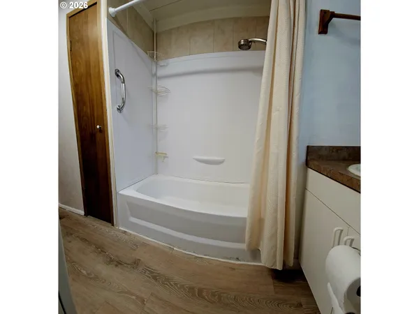 a bathroom with a tub and a shower
