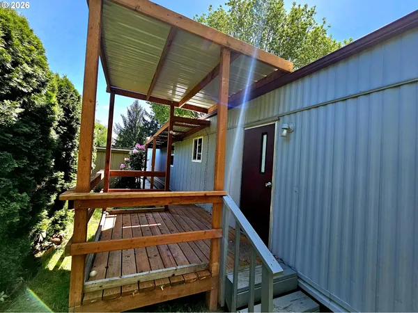 a view of balcony with wooden floor and outdoor seating