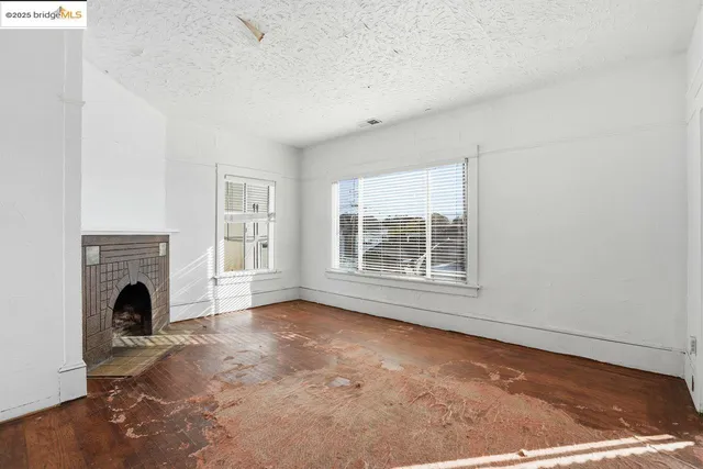 a kitchen with a sink a stove and wooden floor