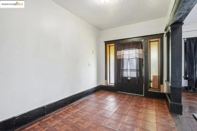 a view of an empty room with glass door