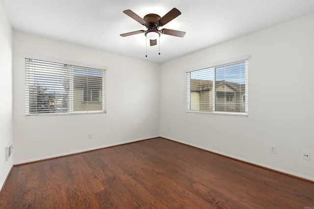 a view of a room with wooden floor and chandelier