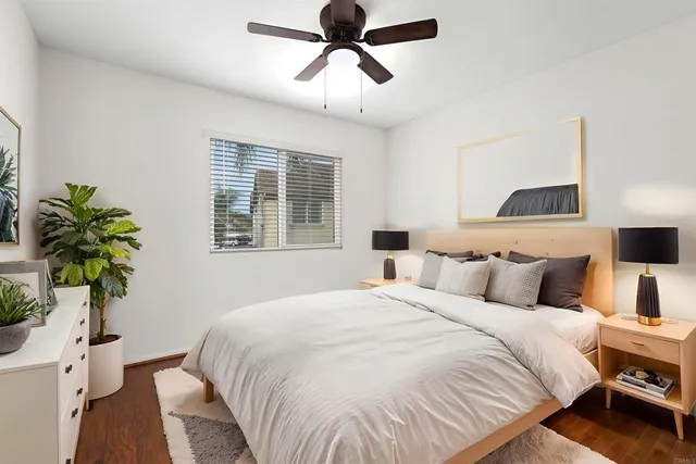 a bedroom with a bed and a potted plant