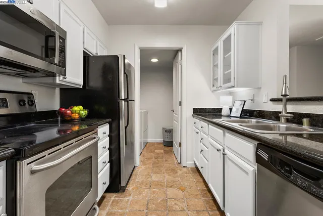 a kitchen with a refrigerator and a sink