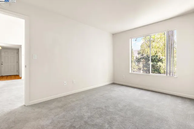 an empty room with closet and a bathroom
