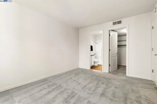 a view of walk in closet with empty racks