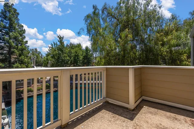 a view of a garden with swimming pool and sitting area